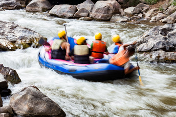 Motion blur of young person rafting on the river, extreme and fun sport at tourist attraction