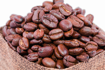 Coffee beans in a burlap bag isolated on white background