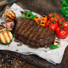 Beef grilled steak with grilled vegetables close up