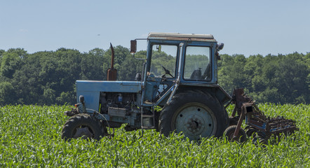 Old tractor running in the field