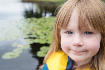 Fototapeta premium Cute young girl at a lake