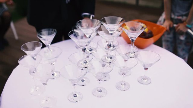 a man lays glasses on the table