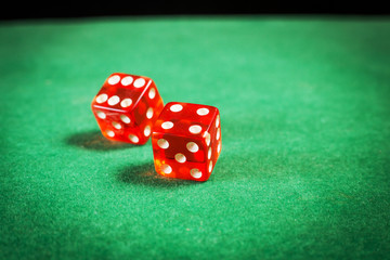 red dice over green surface image close up