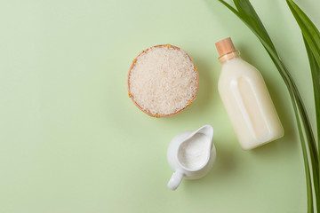 Milk and rice in bowl on light background.