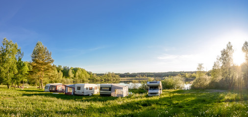 Caravans and camping on the lake. Family vacation outdoors, travel concept