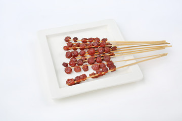 star gooseberry candy on white ceramic plate.