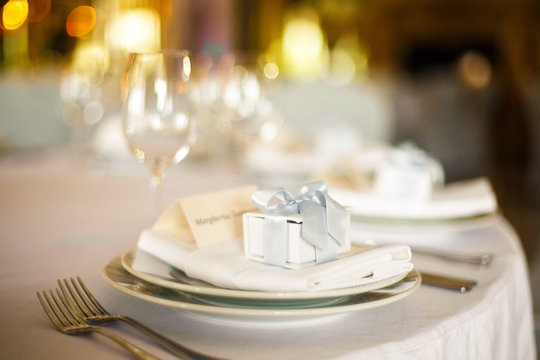 Little present box stands on the white dinner plate