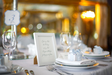 Little present box stands on the white dinner plate