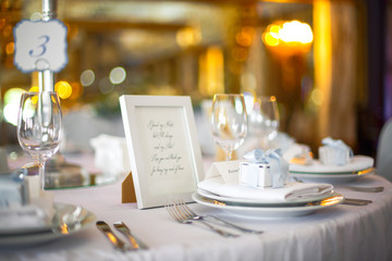 Little present box stands on the white dinner plate