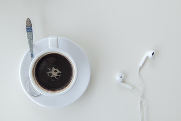 coffee and Earphone  on wood table white background,top view