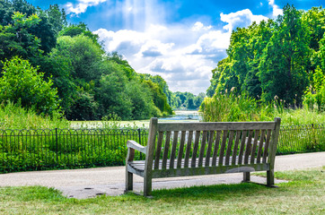 Wooden bench at St James's Park on a summer day, London