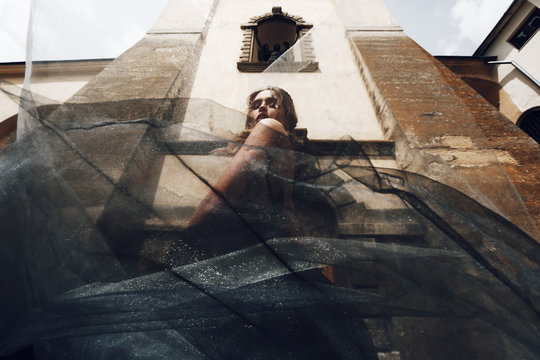 Look from below at gorgeous woman in rich black and grey dress