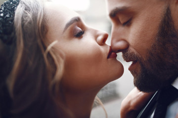 Woman kisses man's nose tender