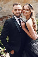 Woman leans to her bearded man posing outside