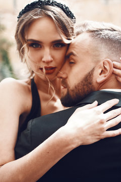 Woman with stunning red lips hugs her bearded man tender