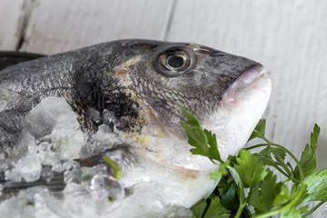 Fresh raw fish on wooden board. Background. From above