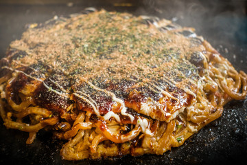 お好み焼き Okonomiyaki is a Japanese-style pancake
