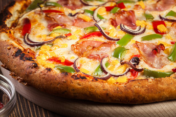 Homemade pizza with bacon, paprika and corn