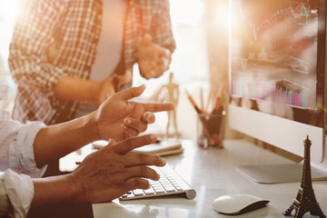 Fototapeta premium Coworking process photo. Account managers team work new idea.Young business crew working with startup modern office. Desktop computer on table, showing presentation.