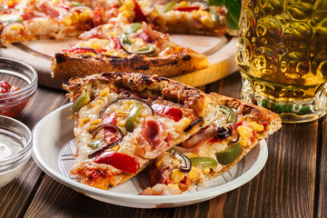 Slices of pizza with bacon, paprika and corn
