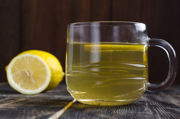 cup of green tea on a table with lemon