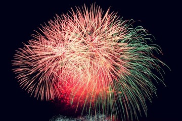 Firework. Beautiful colorful fireworks on the water surface with a clean black background. Fun festival and contest of Firefighters  Brno Dam - Czech Republic.
