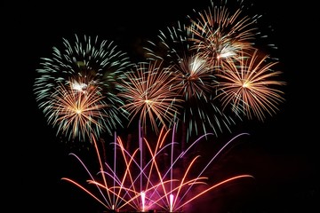 Firework. Beautiful colorful fireworks on the water surface with a clean black background. Fun festival and contest of Firefighters  Brno Dam - Czech Republic.