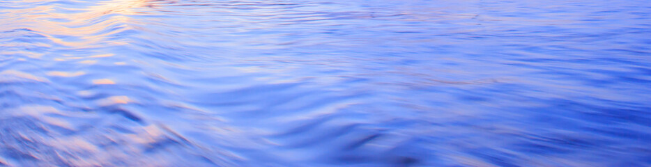 Light reflection on blue river wave ripples surface. Abstract, tranquility,romance.