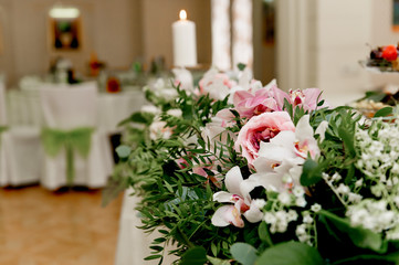 Wedding table decoration newlyweds. Songs on the table of flowers.The pink and white palette, rose, Orchid