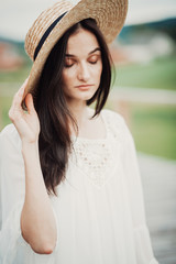 Pretty brunette woman in hay hat