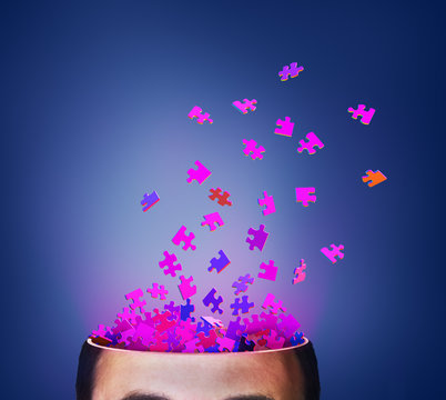 Concept of thinking. Brainstorm. Parts of puzzle exploding from cut of head. 3d illustration