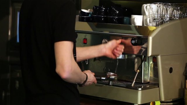 Barman making coffee, The bartender at the back face is not visible, Barista makes coffee, Interior bar