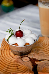 cheesecake with cherries in tartlets. On wooden frame interesting shapes