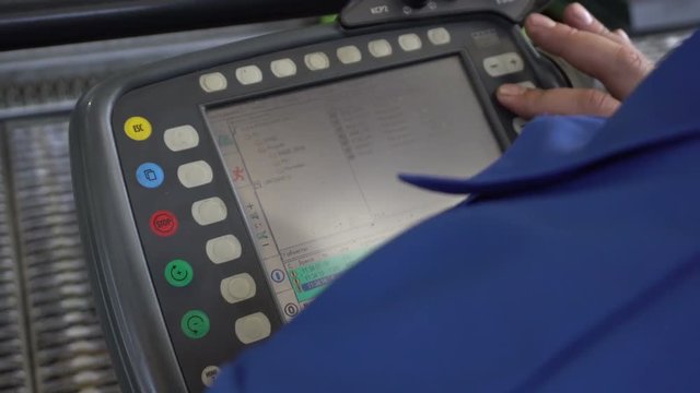 The operator presses the buttons on the monitor