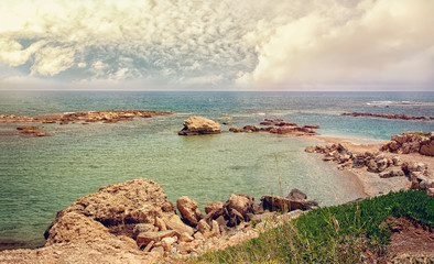 Fototapety  Beautiful views of the sea and the rocky coast of Cyprus with a cloudy sky on a Sunny day. The horizontal frame.