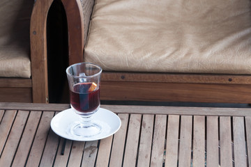 glass with mulled wine on a little table in cafe