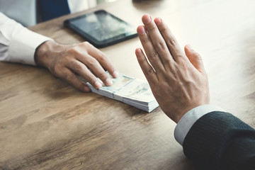 Businessman rejecting money that offered by a man-