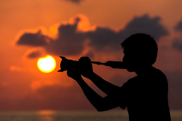 Silhouettes of photographers with the sunrise.