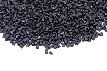 Black plastic polymer granules on white background