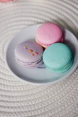 Macaroon pastel tones on a wooden background. Beautiful sweets