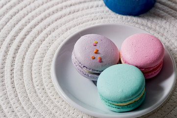Macaroon pastel tones on a wooden background. Beautiful sweets