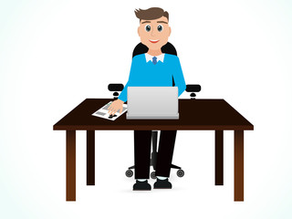 Young businessman working with laptop at table on blue backgrou