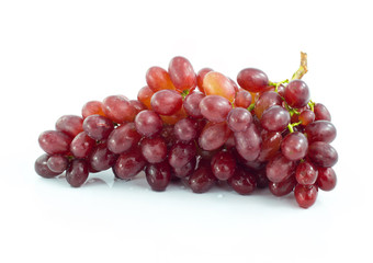 Ripe red grape. Pink bunch with leaves isolated on white. With clipping path. Full depth of field.