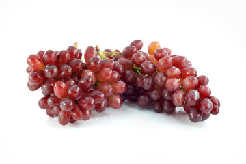 Ripe red grape. Pink bunch with leaves isolated on white. With clipping path. Full depth of field.