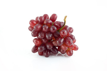 Ripe red grape. Pink bunch with leaves isolated on white. With clipping path. Full depth of field.