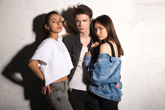 Concentrated Young Hipster Man Standing With Friends Women