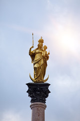 Golden Virgin Mary on the central square Marienplatz in Munich, Germany...