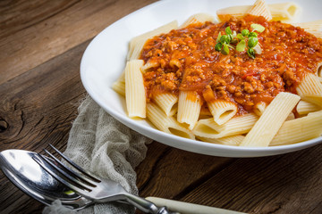 Pasta penne with tomato bolognese sauce.