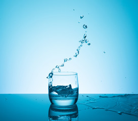 Creative splashing water in the glass