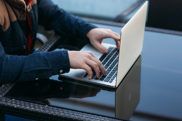 Fototapeta premium The young bank employee works on a laptop at lunchtime.